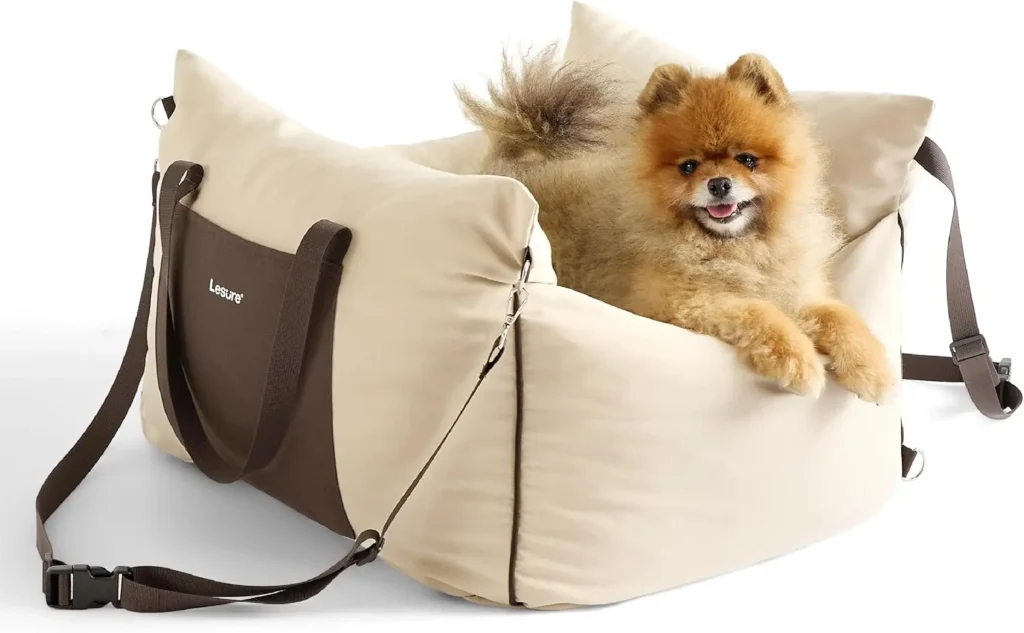 Pomeranian dog relaxing comfortably inside a beige Lesure plush calming car seat on a car back seat.